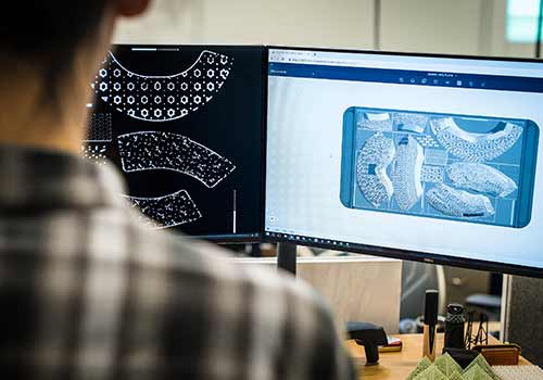 Someone using a computer to design a 3D object